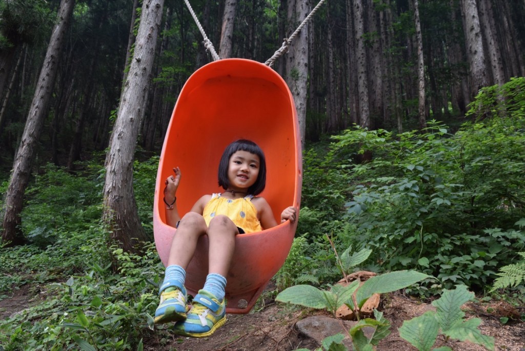 Kid in a swing couldn't be happier